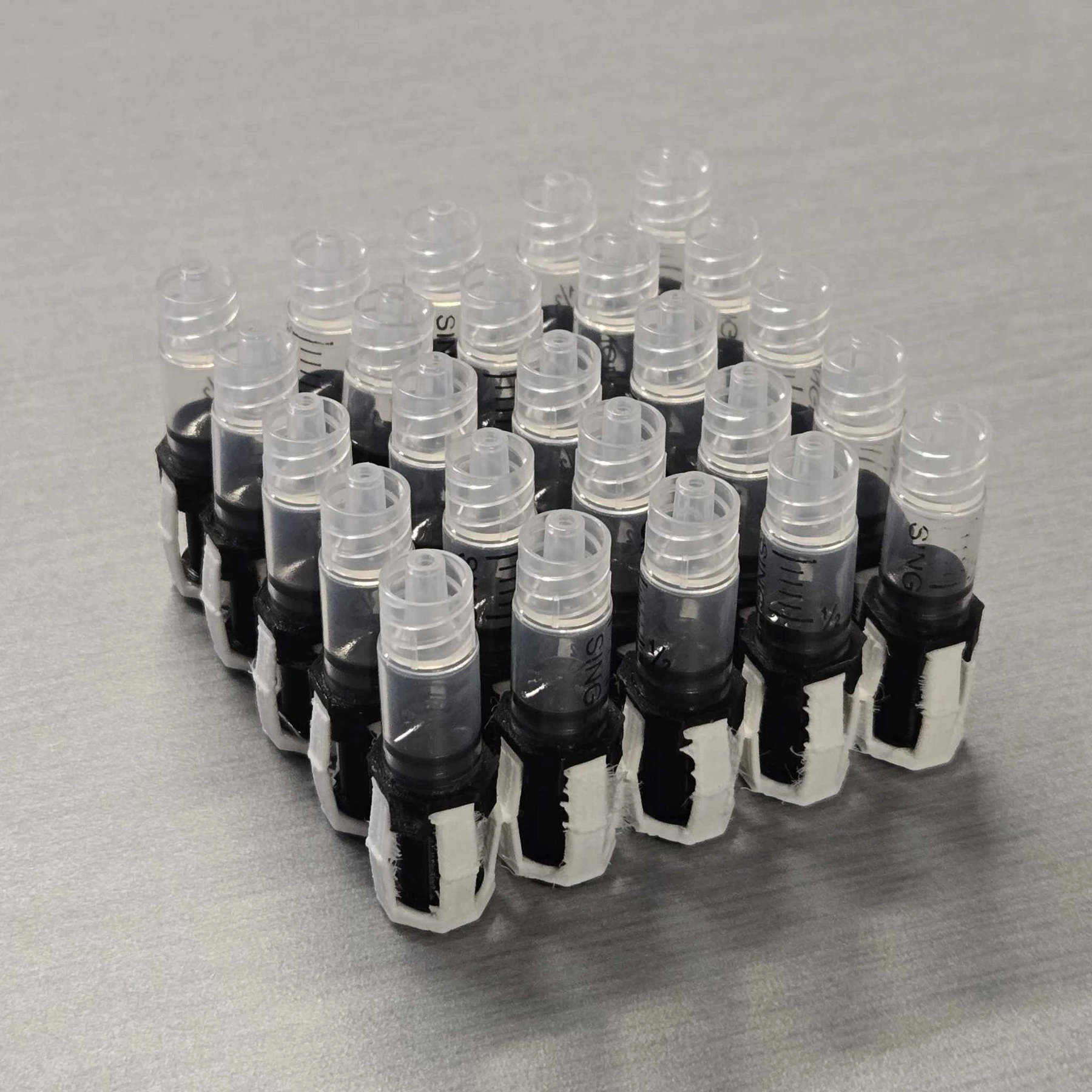 An assembled array of syringes in printed compliant linkages