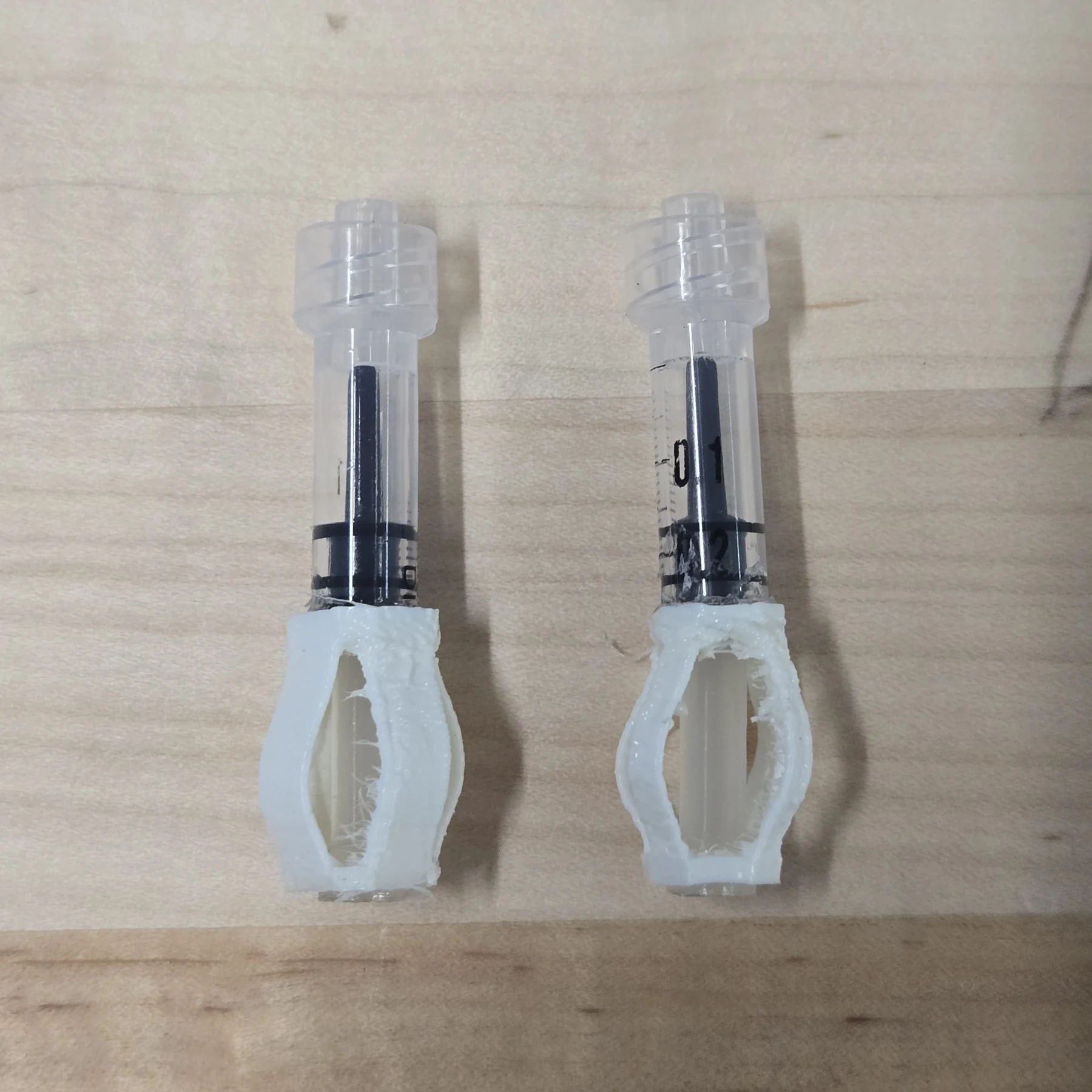 Two syringes integrated with printed compliant linkages